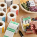 A set of Noble 2-inch by 2-inch dissolvable day of the week label rolls used for food storage and organization.