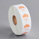 a roll of white paper with orange and white stickers