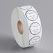 A white roll of paper with black clock labels with black text on it.