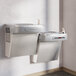 Elkay stainless steel bi-level wall mount chilled drinking fountain with two water dispensers.