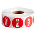 A roll of 1000 Point Plus Paid Permanent stickers with red circles.