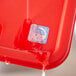A red tray with a blue and white Noble Products day of the week sticker on it.