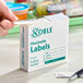 A box of Noble 1" x 2" dissolvable hospital labels containing 500 labels per roll.