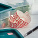 A blue container of food with a Noble Products Wednesday label on it.