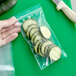 a cucumber slice on a green surface