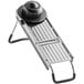 A stainless steel mandoline with a black cap on top.