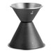 A black measuring cup with measuring numbers on a table.