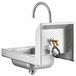 A silver stainless steel Regency wall mounted hand sink with a gooseneck sensor faucet.