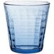 A blue Duralex Prisme glass tumbler with a patterned design.