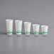 A row of white EcoChoice PLA paper cold cups with green text on the side.