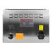 The back of a silver VacMaster VP95 Chamber Vacuum Packaging Machine with a black and yellow label near a power outlet.