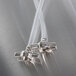 A pair of clear plastic tubes with a nut attached to each end.