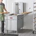 A commercial flat bottom fryer designed for making funnel cakes or donuts, with stainless steel construction and side trays for holding baked goods.