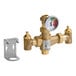 A Guardian Equipment thermostatic mixing valve with a pressure gauge on a gold metal pipe.