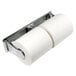 A chrome Winco double roll toilet paper holder with two rolls on it.