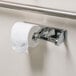 A white Winco self locking double roll toilet paper dispenser holding two rolls of toilet paper.