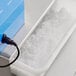 A Carnival King Tub-Style Sno-Cone Machine with ice in the tub on a counter.