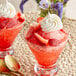 a pair of glasses with strawberries and whipped cream