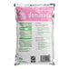A bag of DominAde pink lemonade drink mix with pink and white packaging.