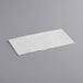 A white rectangular object on a gray surface.
