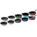 A row of Valor Himalayan salt enameled mini cast iron skillets in blue, green, and black.