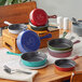 A group of Valor fern green enameled cast iron skillets on a table.