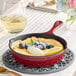 A Valor Merlot enameled cast iron skillet with blueberries and lemon.