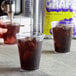 a glass of liquid with ice in it