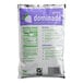A white bag of DominAde grape drink mix with purple and green text.