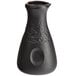 A close-up of a black Acopa stoneware sake bottle with a round neck.