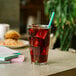 A glass of iced tea with a Phade blue compostable straw in it.