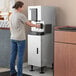 A woman using a Hoshizaki countertop ice and water dispenser.