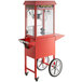 A red Carnival King popcorn popper on a cart with wheels.