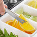 American Metalcraft stainless steel bar tongs holding a lemon and orange slice
