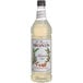 A bottle of Monin Premium Almond Flavoring Syrup with a label.