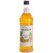 A Monin Hawaiian Island Fruit Syrup bottle filled with orange liquid.