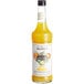 A bottle of Monin Mai Tai Cocktail Mix with yellow liquid and orange and white label.
