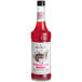 A bottle of Monin HomeCrafted Dragon Fruit Cosmo Cocktail Mix with red liquid inside.