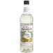 A bottle of Monin Premium Mojito Mix with a white label.