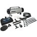 A grey MetroVac canister vacuum with black wheels and accessories.