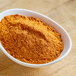 A bowl of Lawry's chili seasoning mix on a wooden table.