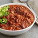 a bowl of chili with a spoon