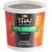 A white container of THAI Kitchen green curry paste.