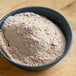 A bowl of Lawry's Spatini spaghetti seasoning mix on a wooden table.