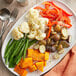 A plate of vegetables with Lawry's seasoning on a table.