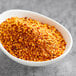 A bowl of Lawry's Roasted Garlic and Red Bell Pepper Seasoning.