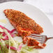 A piece of salmon with Lawry's Sweet Basil, Citrus, and Garlic Rub on a plate with a fork.