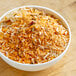 A bowl of Zatarain's Jambalaya mix on a wooden table.