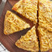 A piece of pizza with Lawry's Pepper Supreme Seasoning on a wood surface plate.