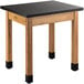 A National Public Seating science lab table with black chem-res top and wood legs.